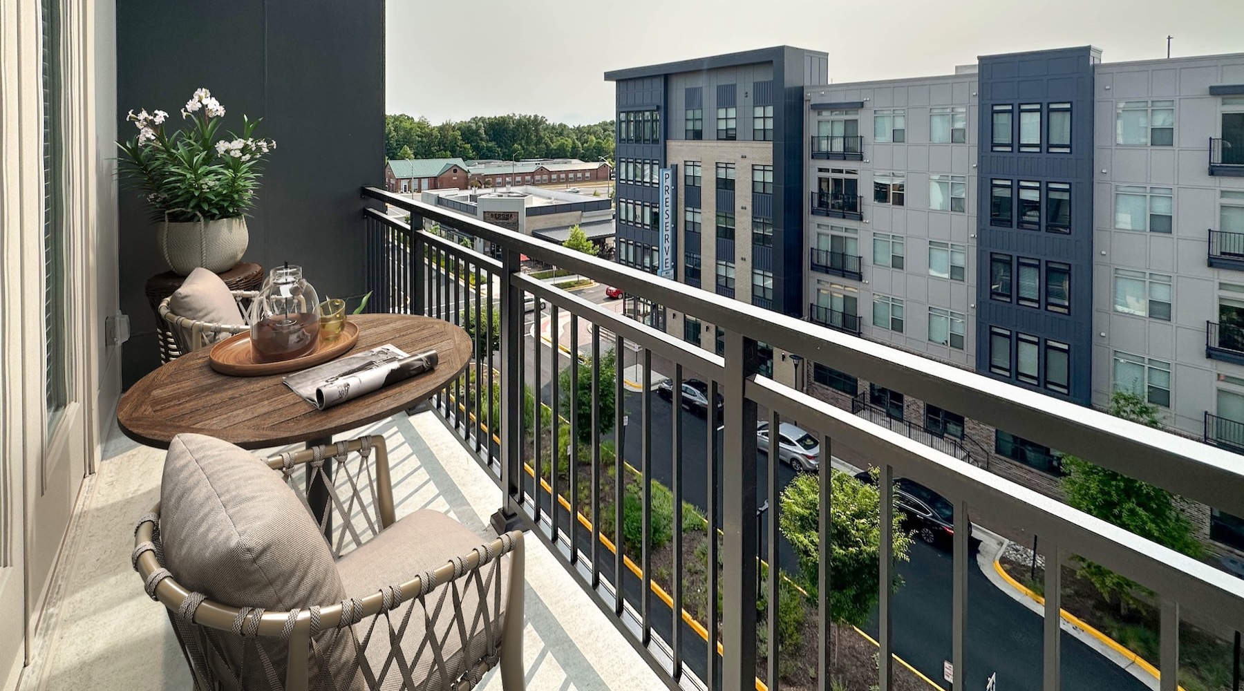 a balcony with a table and chairs